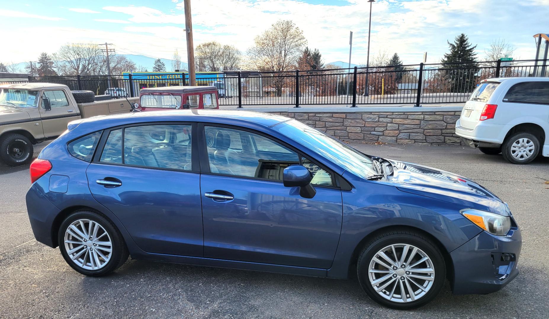 2012 Blue /Black Subaru Impreza Limited 5-Door (JF1GPAG65CH) with an 2.0L H4 DOHC 16V engine, Continuously Variable Transmission transmission, located at 450 N Russell, Missoula, MT, 59801, (406) 543-6600, 46.874496, -114.017433 - Good Runner. Excellent MPG. Automatic Transmission. Heated Seats. Air. Cruise. Tilt. Bluetooth. has Timing Chain. Not a Timing Belt. - Photo#2